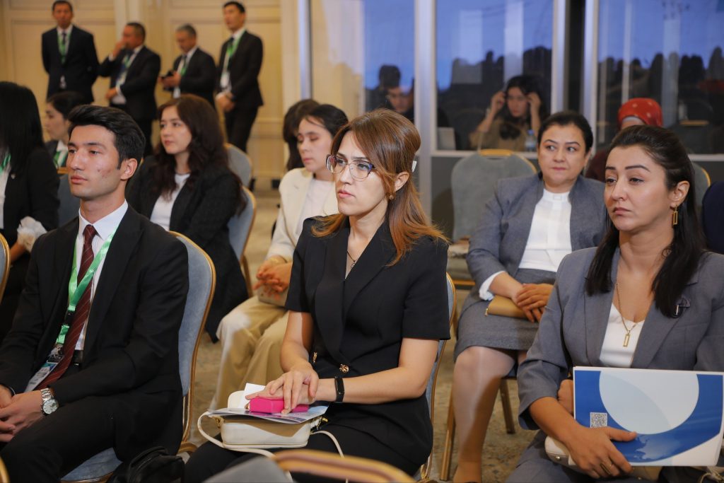 People sitting in the auditorium and listening to presentation